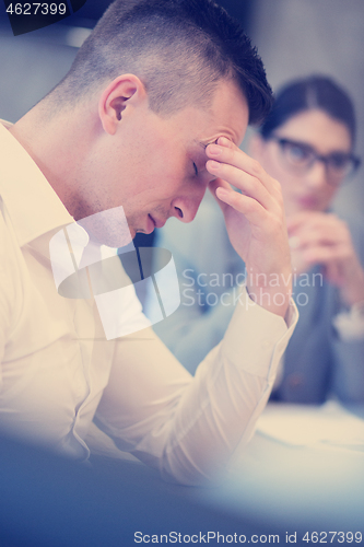 Image of young businessman relaxing at the desk