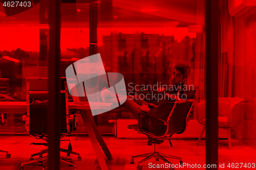 Image of young businessman relaxing at the desk