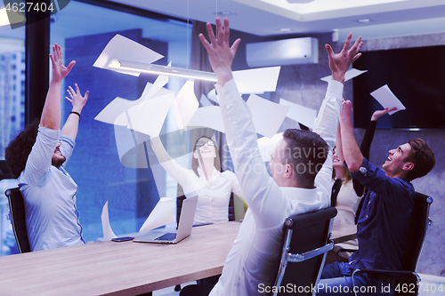 Image of startup Group of young business people throwing documents