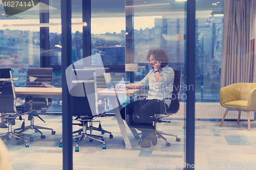 Image of Young casual businessman using smartphone