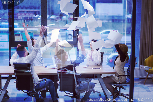 Image of startup Group of young business people throwing documents