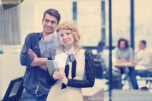 Image of Business People Working With Tablet in startup office