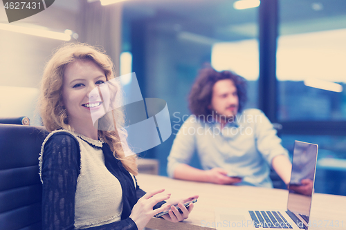 Image of Elegant Woman Using Mobile Phone in startup office building