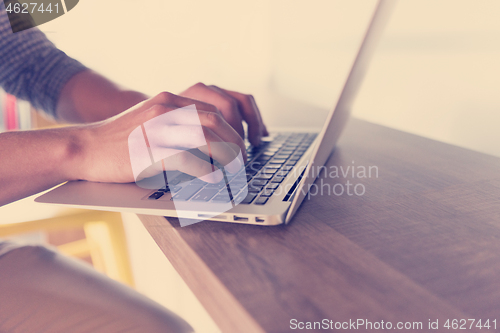 Image of close up of male hands while working in modern office
