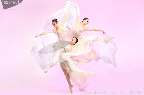 Image of Ballerina. Young graceful female ballet dancer dancing over pink studio. Beauty of classic ballet.