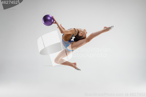 Image of The teenager girl doing gymnastics exercises isolated on white background