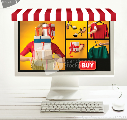 Image of Internet online shopping concept with computer and cart