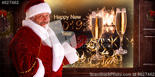 Image of The man in costume of santa claus over night city background