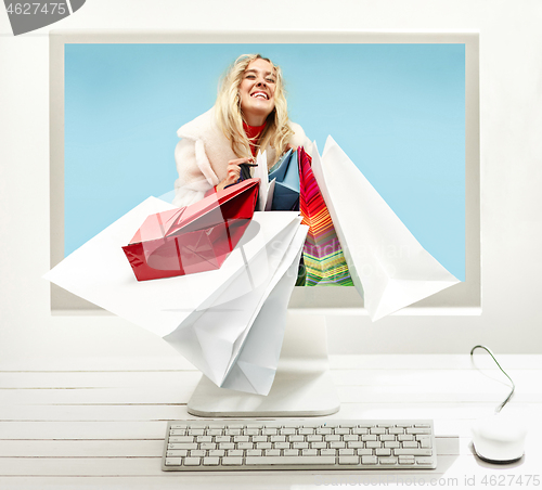 Image of Internet online shopping concept with computer and cart