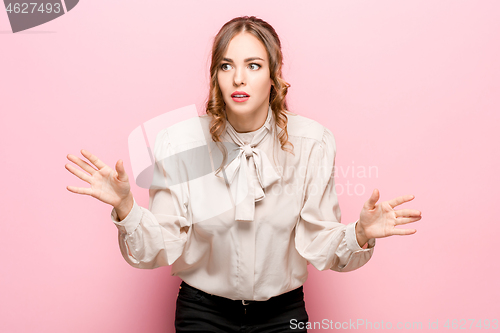 Image of Beautiful woman looking suprised isolated on pink