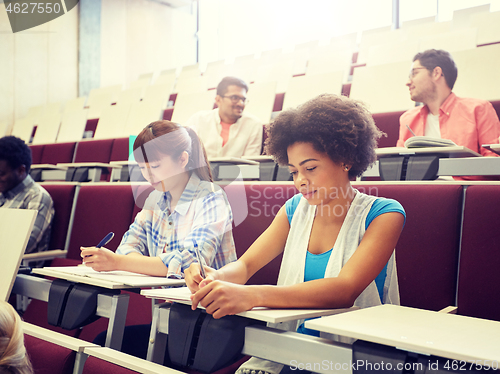 Image of group of students with notebooks at lecture hall