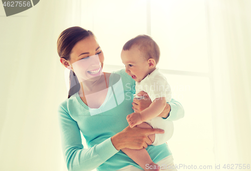 Image of happy young mother with little baby at home