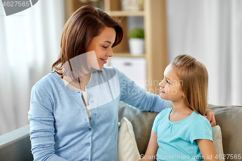 Image of mother and daughter looking at each other at home