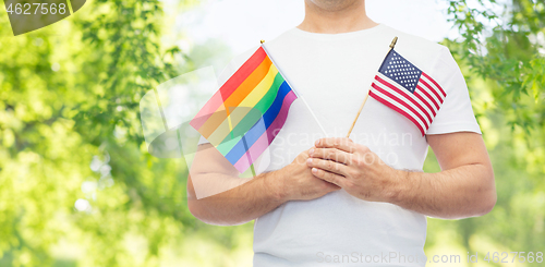 Image of man with gay pride rainbow flag and wristband