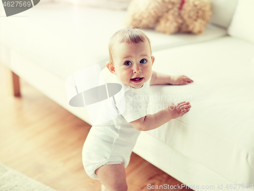 Image of happy little baby boy or girl at home