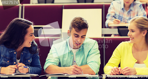 Image of group of students with notebooks in lecture hall