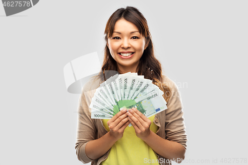 Image of asian woman with hundred euro money banknotes