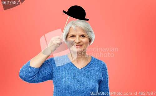 Image of funny senior woman with vintage party hat