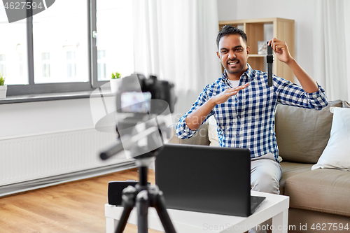 Image of male video blogger with smart watch videoblogging