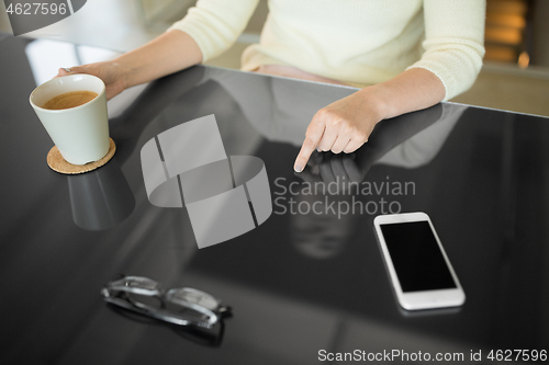 Image of woman with coffee using black interactive panel