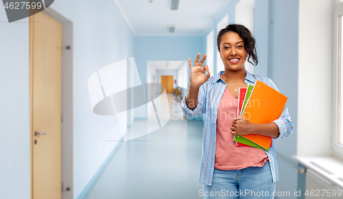 Image of african american student woman with notebooks