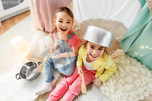 Image of girls with pots playing in kids tent at home