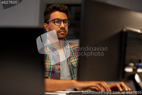 Image of close up of creative man working at night office
