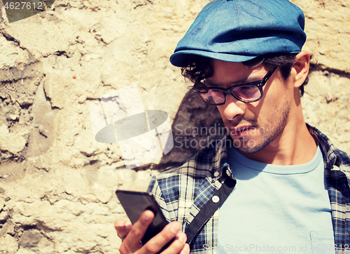 Image of hipster man texting message on smartphone