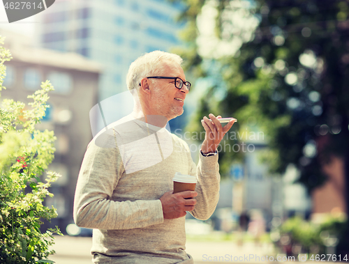 Image of old man using voice command recorder on smartphone