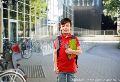 Image of smiling student boy with books and school bag