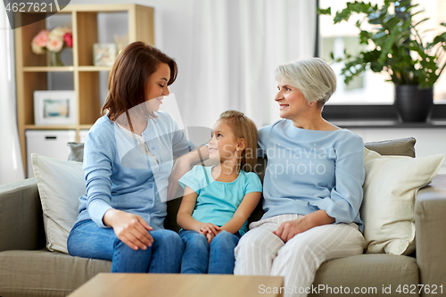 Image of smiling mother, daughter and grandmother