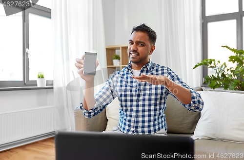 Image of male blogger with smartphone videoblogging