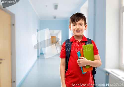 Image of smiling student boy with books and school bag