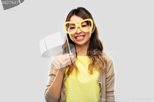 Image of happy asian woman with big party glasses