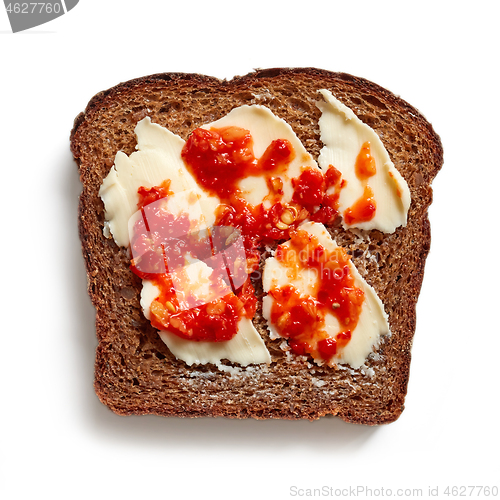 Image of slice of rye bread with butter and chili