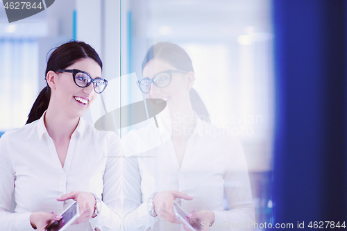 Image of Business Woman Using Digital Tablet in front of startup Office