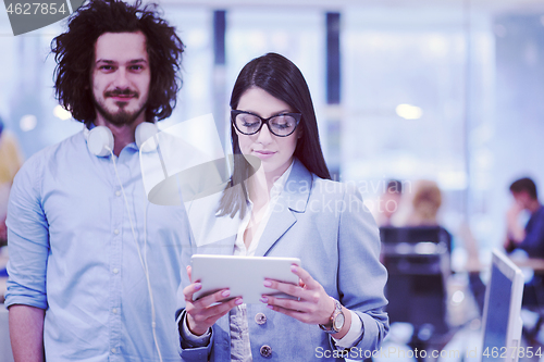 Image of Business People Working With Tablet in startup office