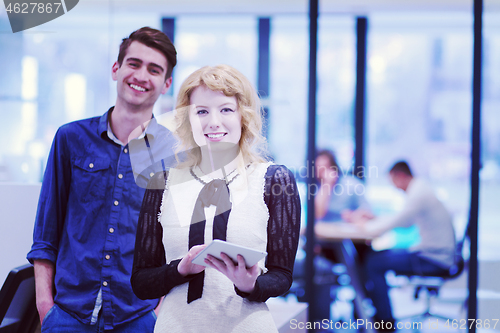 Image of Business People Working With Tablet in startup office