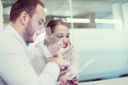 Image of Business People Working With Tablet in startup office