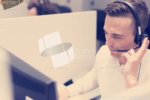 Image of male call centre operator doing his job