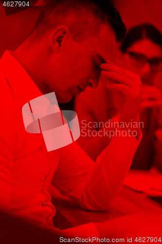 Image of young businessman relaxing at the desk