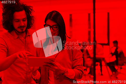 Image of Business People Working With Tablet in startup office