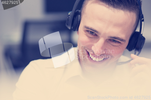 Image of male call centre operator doing his job