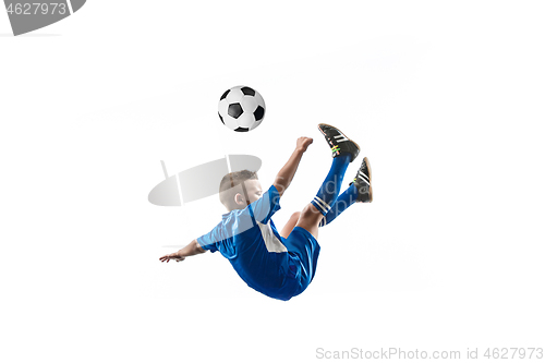 Image of Young boy with soccer ball doing flying kick