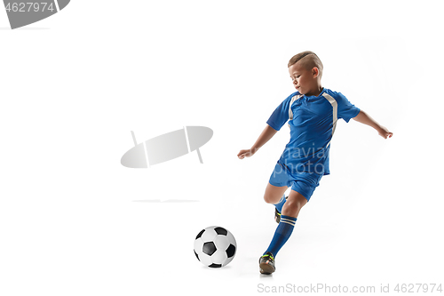 Image of Young boy with soccer ball doing flying kick