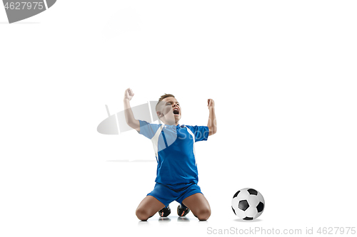 Image of Young boy with soccer ball doing flying kick