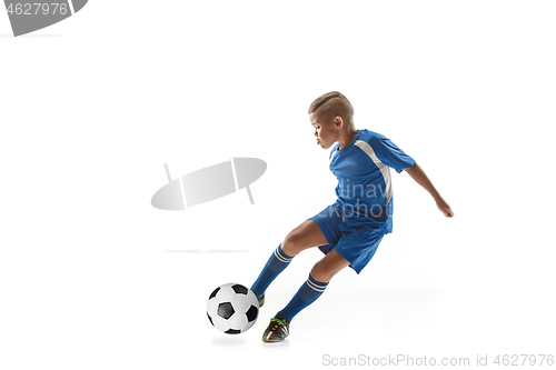 Image of Young boy with soccer ball doing flying kick