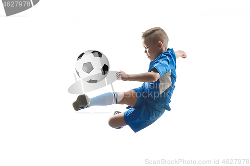 Image of Young boy with soccer ball doing flying kick