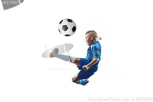 Image of Young boy with soccer ball doing flying kick