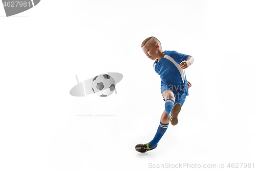 Image of Young boy with soccer ball doing flying kick